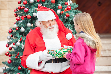 Image showing Santa Claus Giving Present To Girl