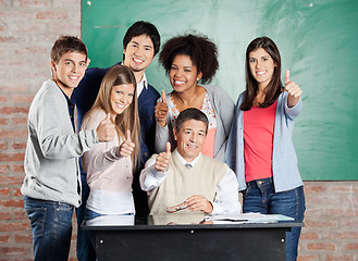 Image showing Students And Professor Gesturing Thumbsup At Desk In Classroom