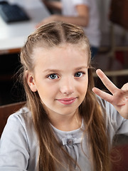 Image showing Schoolgirl Gesturing Victory Sign In Computer Lab