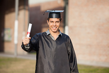 Image showing Confident Student Showing Diploma On Graduation Day At Campus