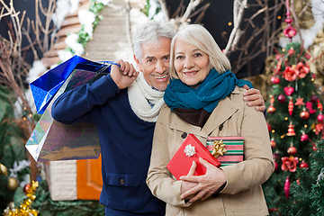 Image showing Couple With Shopping Bags And Present At Christmas Store