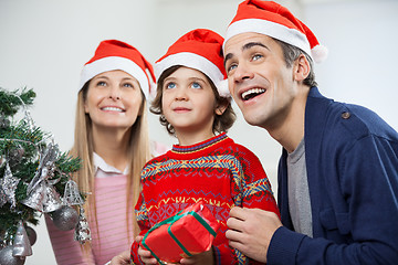 Image showing Happy Family With Christmas Gift Looking Away