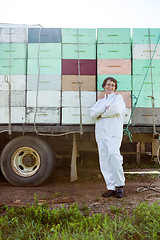 Image showing Beekeeper Standing Against Truck Loaded With Crates