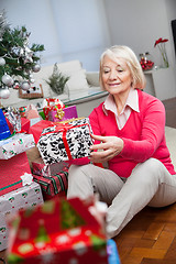 Image showing Senior Woman Looking At Christmas Gift