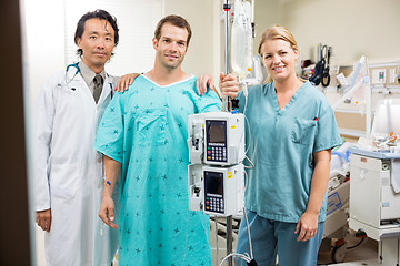 Image showing Patient With Doctor And Nurse Standing By Machine Stand