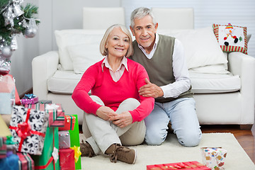 Image showing Happy Senior Couple Sitting By Christmas Presents