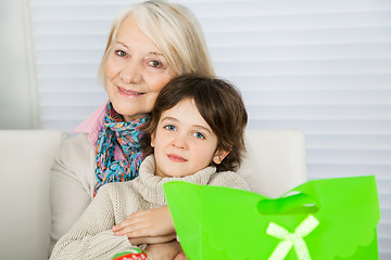 Image showing Senior Woman Embracing Boy During Christmas