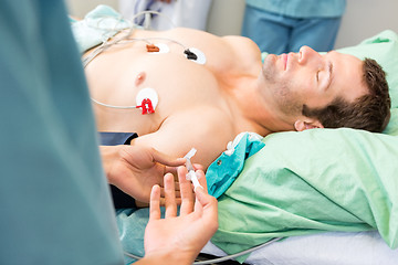 Image showing Female Nurse Injecting Critical Patient On Arm