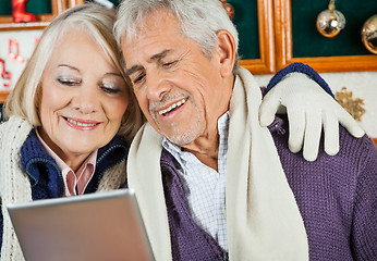 Image showing Couple Using Digital Tablet At Christmas Store