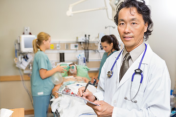 Image showing Doctor Holding Clipboard in Emergency