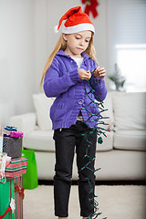 Image showing Girl Holding Fairy Lights During Christmas