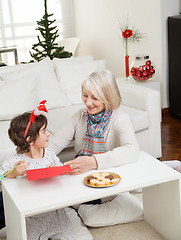 Image showing Woman Assisting Boy In Making Christmas Greeting Card