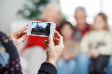 Image showing Mother Photographing Family Through Smartphone