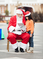 Image showing Santa Claus And Girl Using Digital Tablet