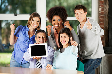 Image showing Teacher Holding Digital Table With Students Gesturing In Classro