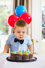 Image showing Boy Blowing Candles On Cake