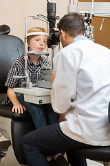 Image showing Optician Examining Boy's Eyes With Slit Lamp