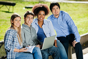 Image showing Friends With Laptop And Book Sitting In Campus