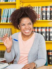 Image showing Student Waving While Looking Away In College Library