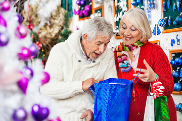 Image showing Surprised Couple Looking Into Shopping Bag