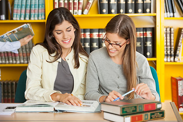 Image showing Friends Studying At Table In Library