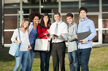 Image showing Happy Students With Teacher Standing On College Campus