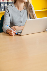 Image showing Student With Laptop Sitting At Table In University Library