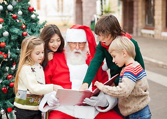 Image showing Children And Santa Claus Reading Book