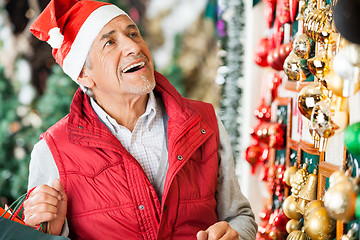 Image showing Man Selecting Christmas Ornaments At Store