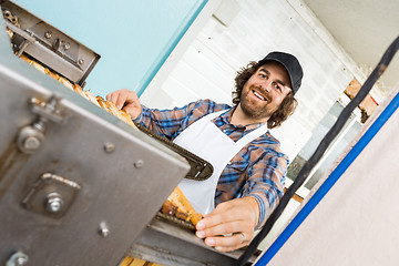 Image showing Beekeeper Standing At Honey Extraction Plant