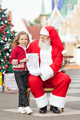Image showing Happy Girl Giving Letter To Santa Claus
