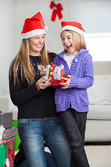 Image showing Cheerful Daughter And Mother With Christmas Present