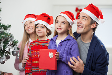 Image showing Family In Santa Hat With Christmas Present