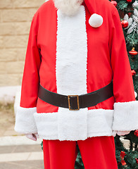 Image showing Santa Claus Standing Against Tree