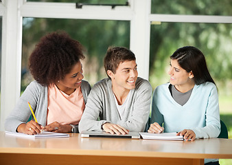 Image showing Students Looking At Friend While Sitting In Classroom