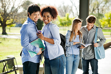 Image showing Student Showing Cellphone To Friend At Campus