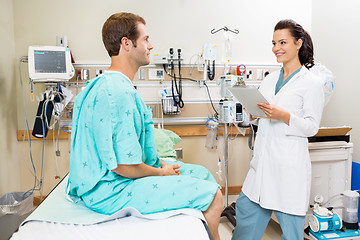 Image showing Doctor With Clipboard Checking Patient's Report
