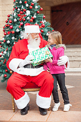 Image showing Santa Claus Giving Gift To Girl