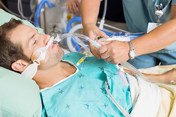 Image showing Nurse Adjusting Endotracheal Tube In Patient's Mouth