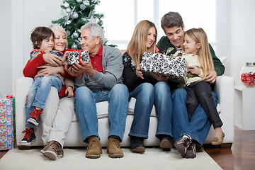 Image showing Family With Christmas Presents Sitting In House