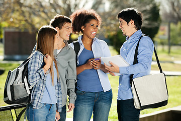 Image showing Cheerful Students Looking At Friend In Campus