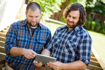 Image showing Construction Workers Discussing Project On Digital Tablet