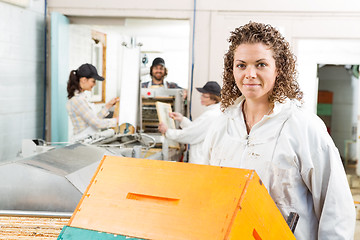 Image showing Female Beekeeper With Stacked Honeycomb Crates