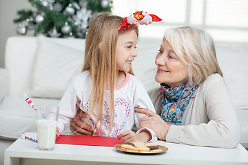 Image showing Grandmother And Girl With Cardpaper Looking At Each Other