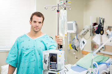 Image showing Patient Holding Stand With Machine And Drip Bag