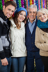 Image showing Family Standing Against Tinsels At Store