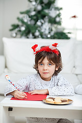 Image showing Boy Wearing Headband Writing Letter To Santa Claus