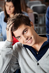 Image showing Man With Hand In Hair Smiling At Classroom