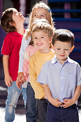 Image showing Boy Standing With Friends In A Row At Kindergarten