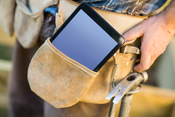 Image showing Tablet Computer And Hammer In Carpenter's Tool Belt